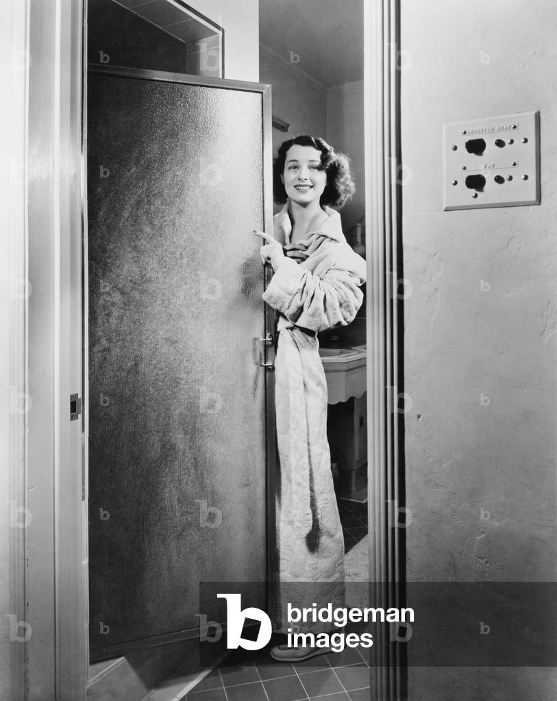 Portrait of a Young Woman Standing at a Door of a Bathroom