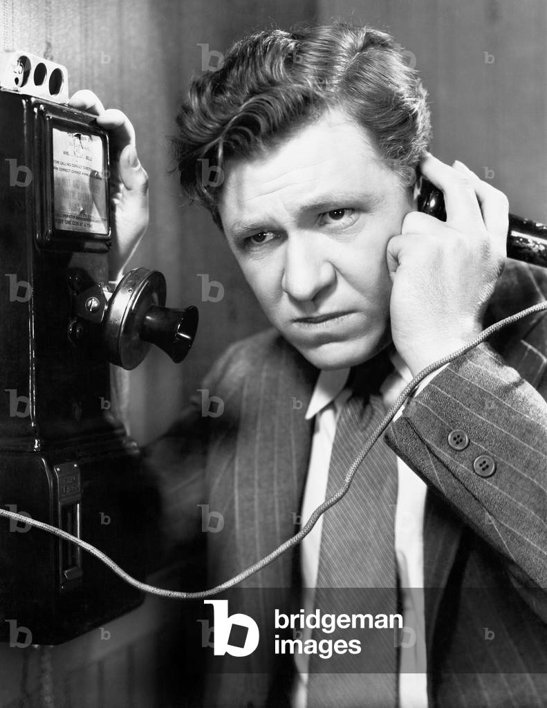 A Man Listening on the Telephone