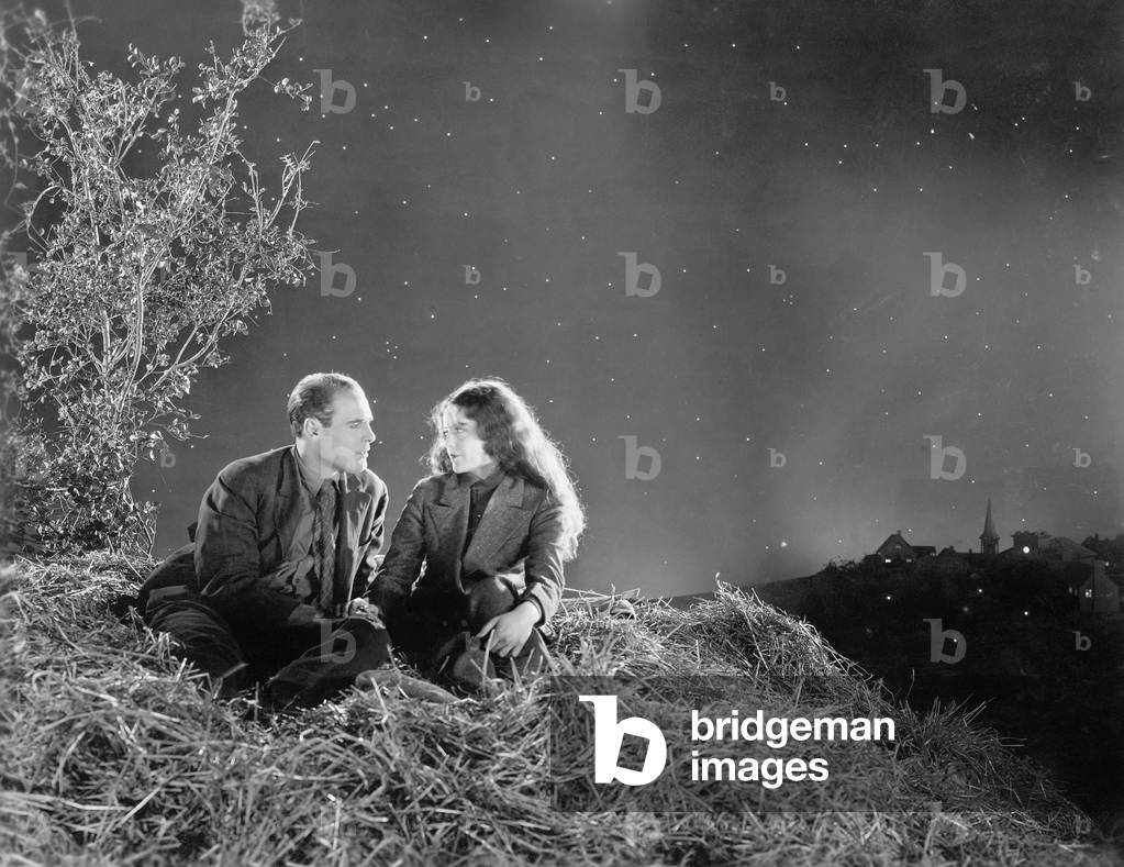 Romantic Couple Sitting on a Stack of Hay Under the Stars