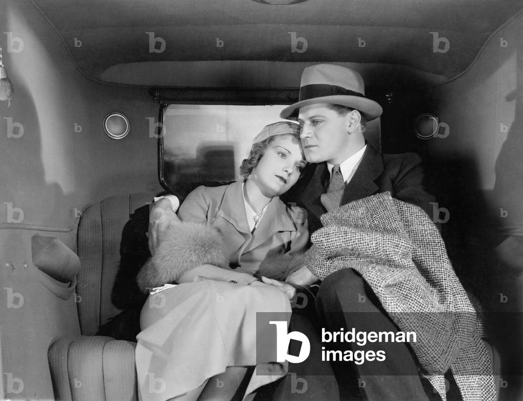 Couple Sitting Together on the Back Seat of a Car