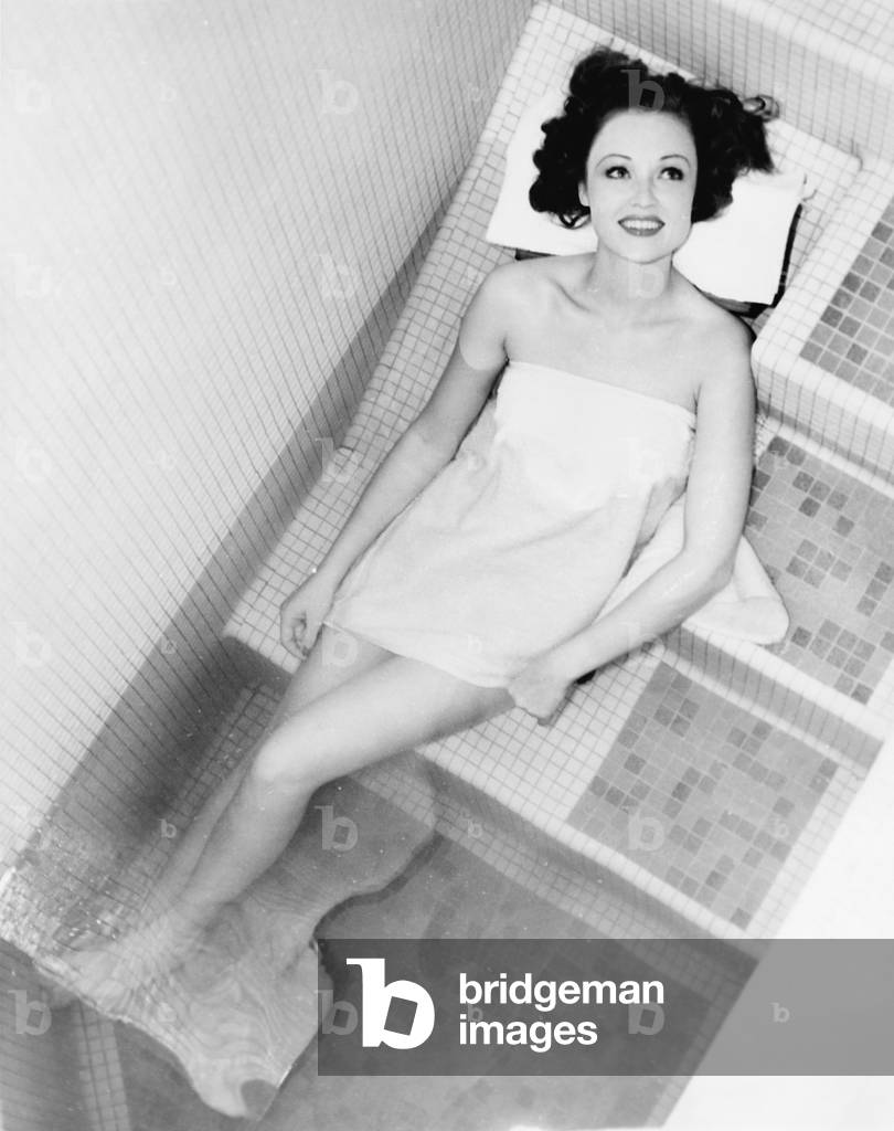 Woman Lying on the Steps of a Spa Bath