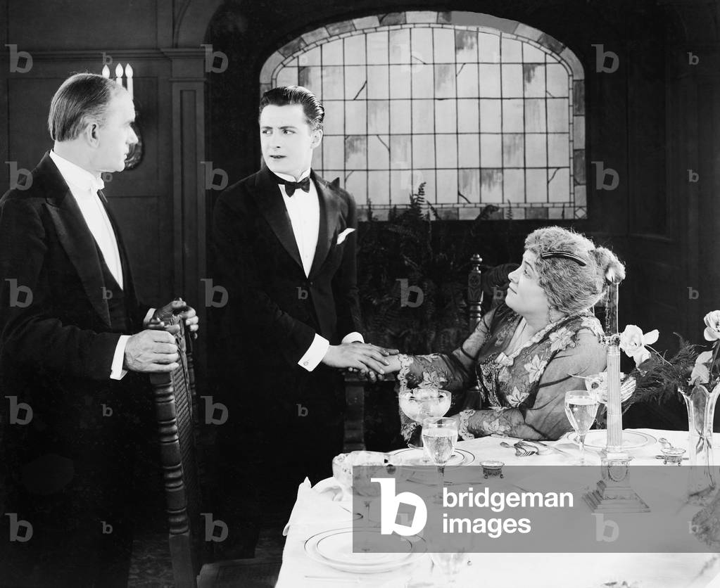 Young Man Greeting a Couple at the Dinner Table