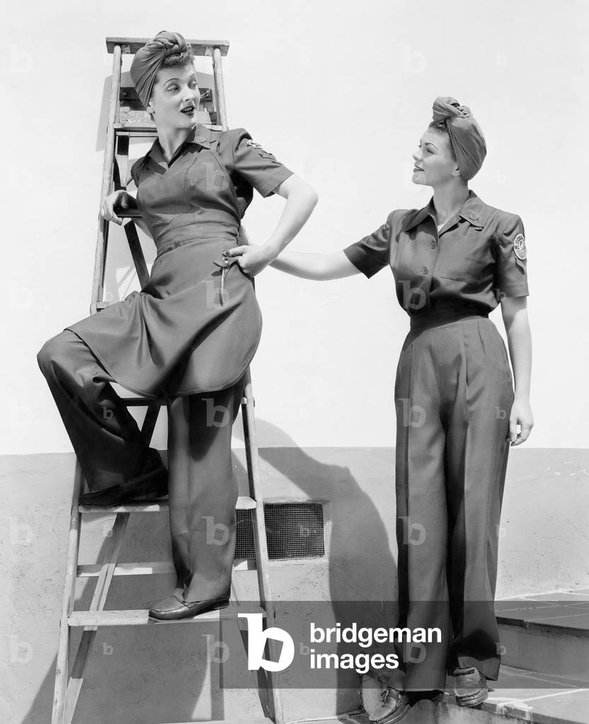Two Women Standing Together on a Ladder and Stairs