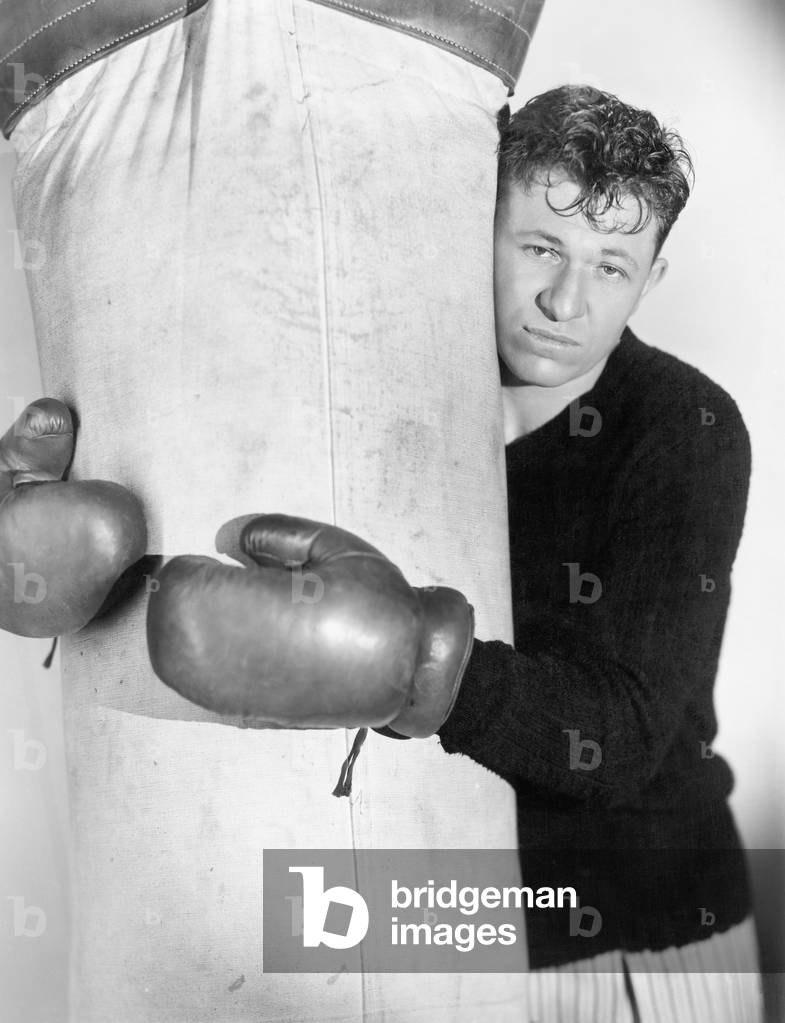 Man in Boxing Gloves Hugging the Punching Bag