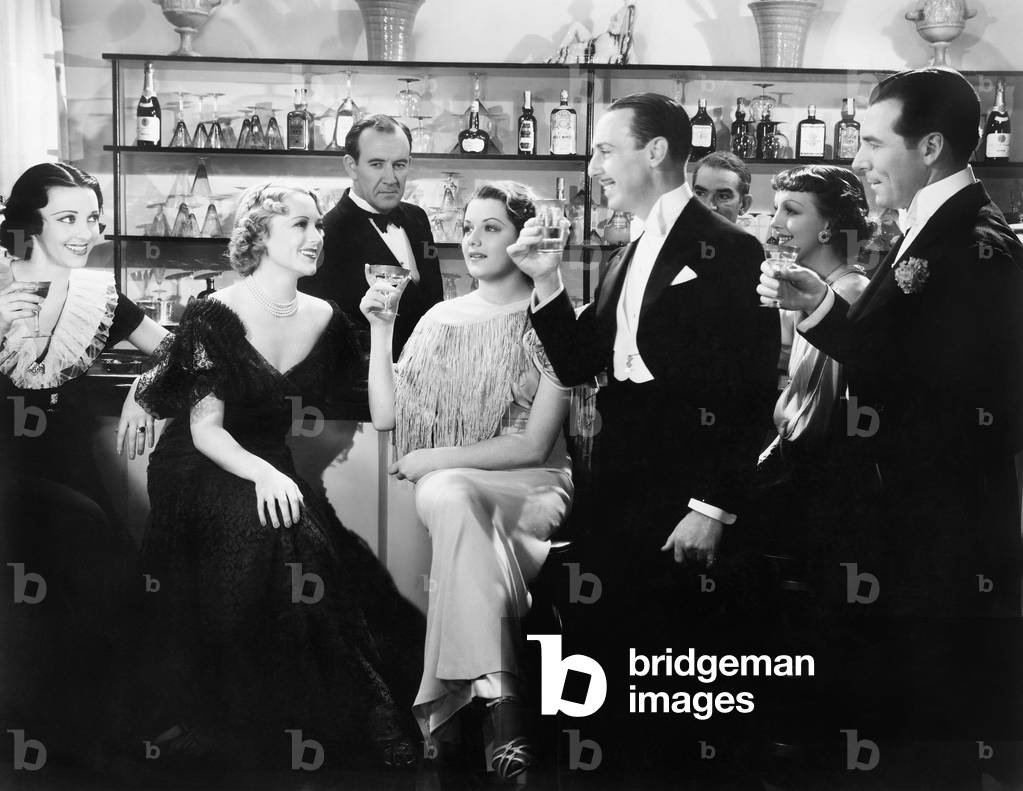 Elegant Group of People at a Bar Toasting a Woman