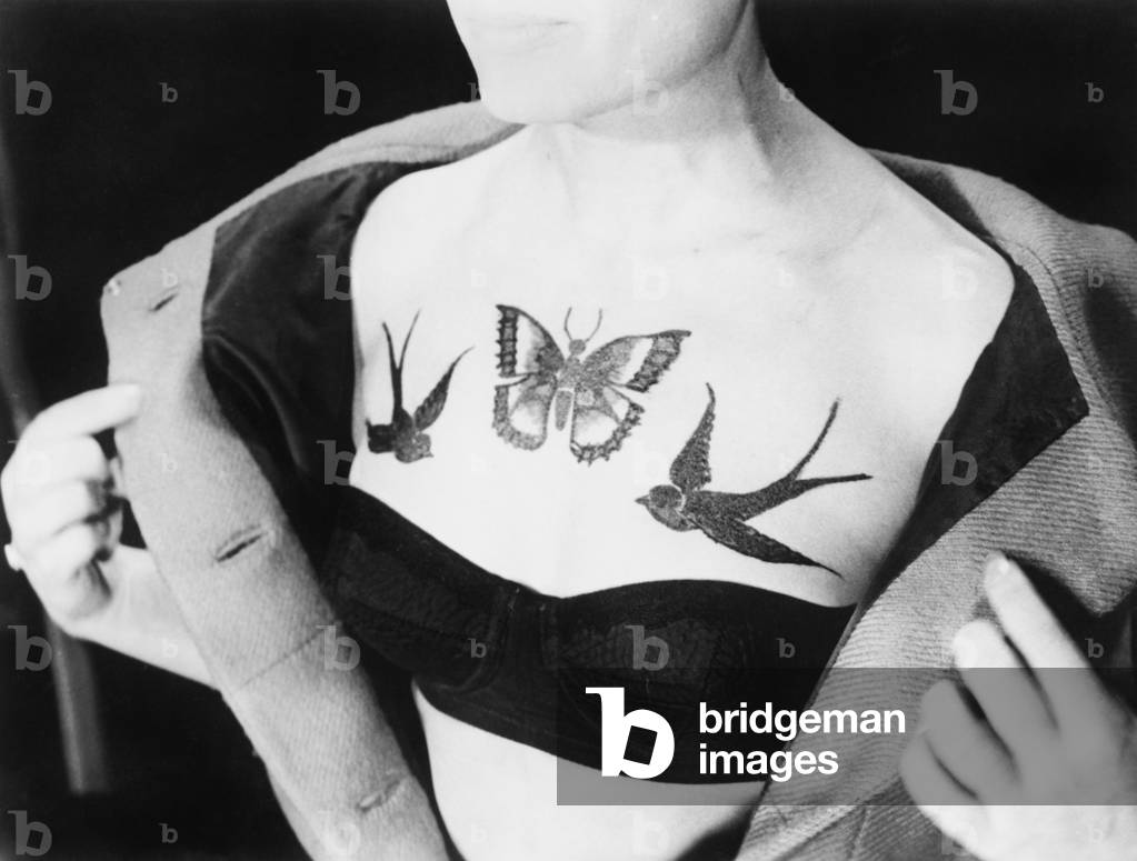 Close-Up of a Woman Showing Tattoos on her Chest