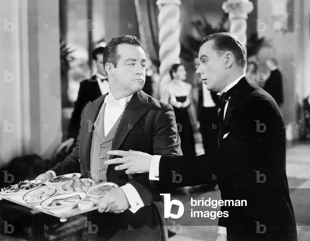 A Waiter and Patron at a Gala Event