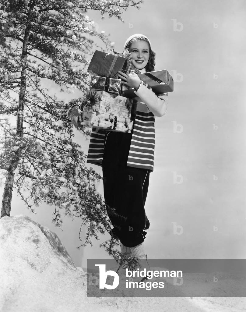 Woman Outside in Snow with Christmas Presents
