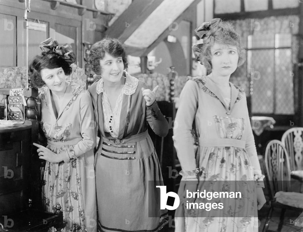 Two Women Looking at a Third Woman