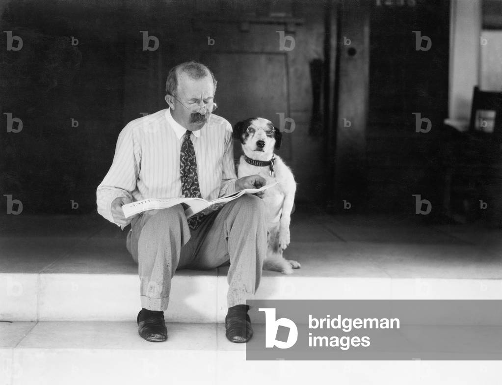 Man and Dog Sitting on the Steps Reading the Newspaper