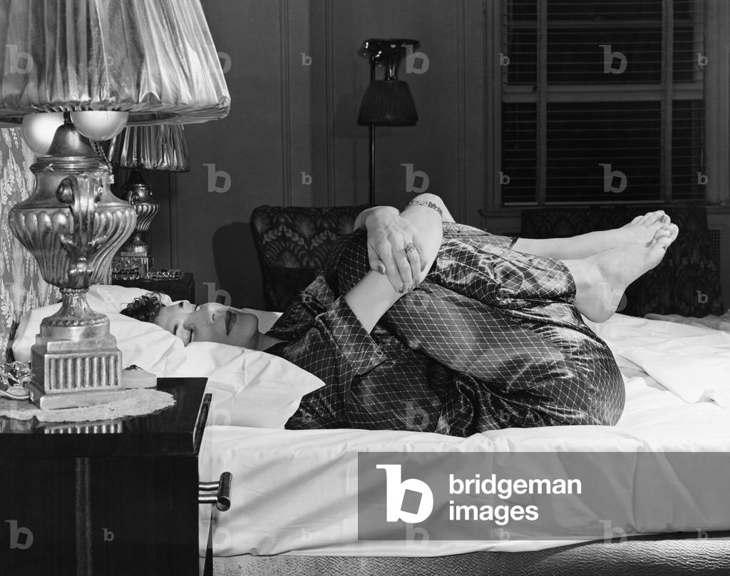 Woman Stretching on Bed
