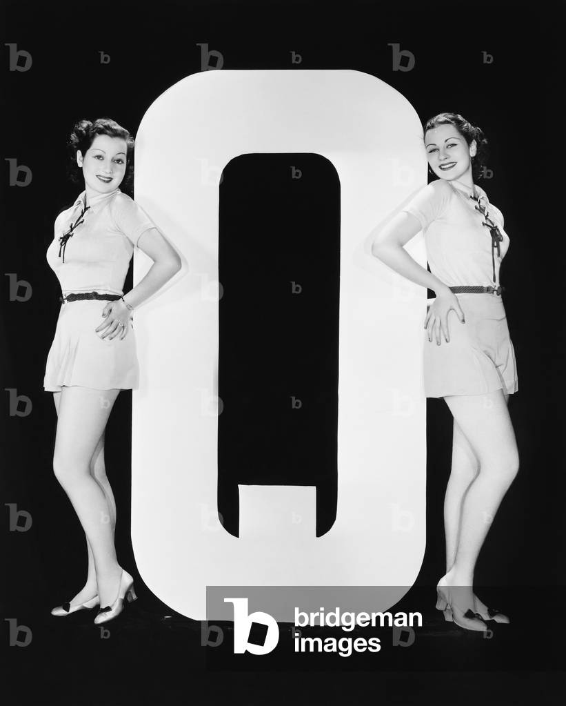 Women Posing with Huge Letter Q