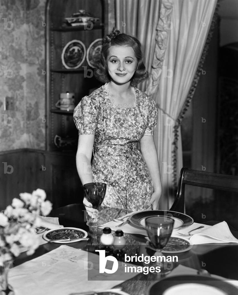 Portrait of Woman Setting Dining Table