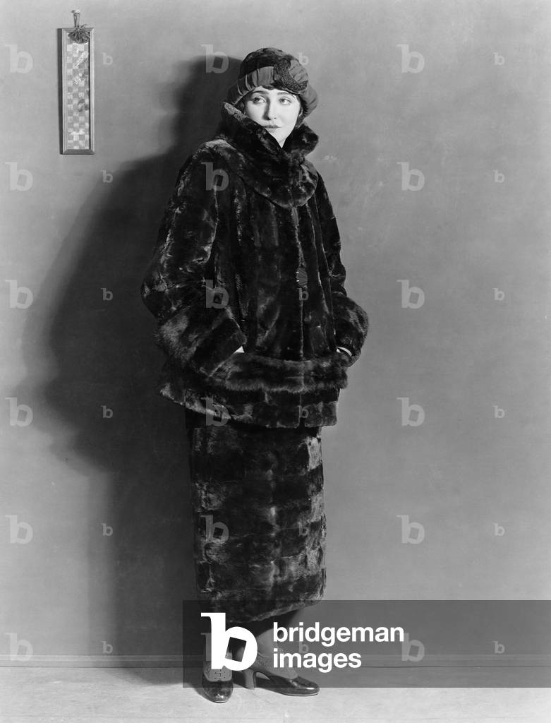 Woman Wearing Fur Coat and Skirt