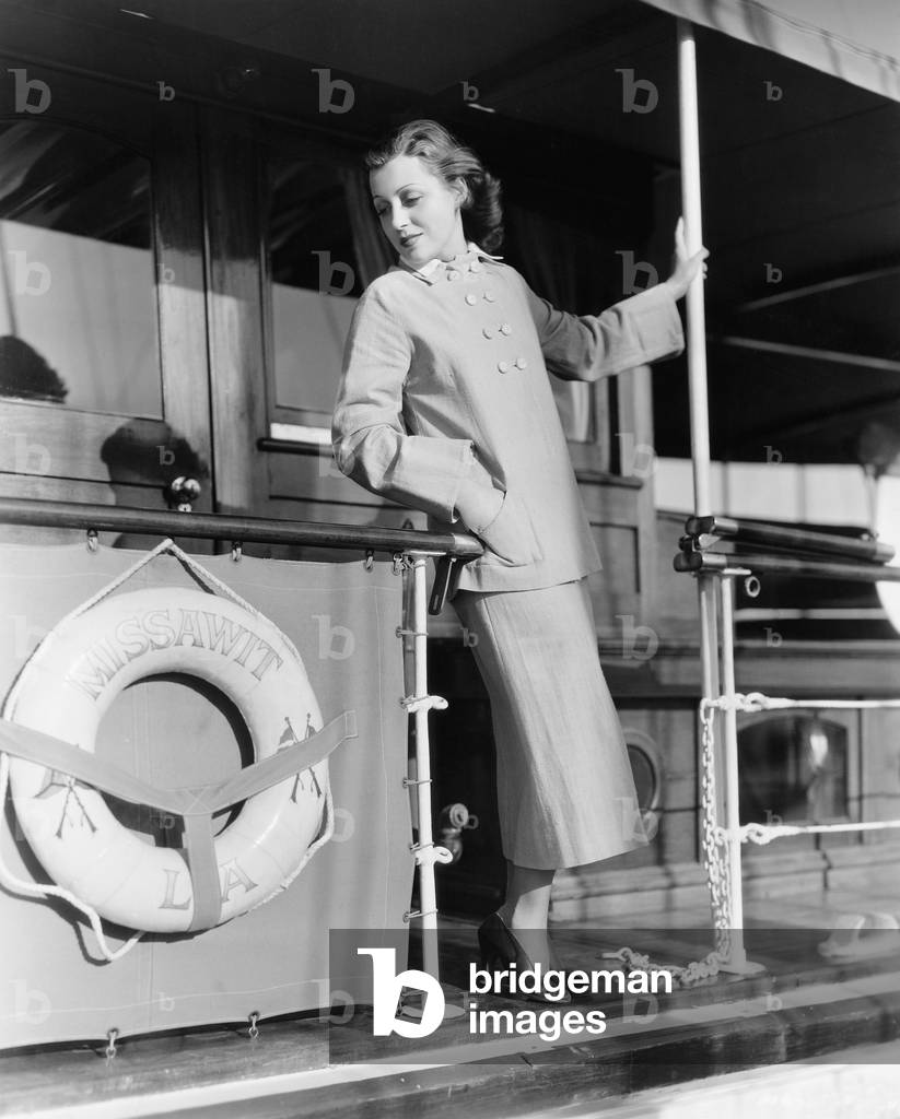 Young Woman Standing at the Railing of a Boat