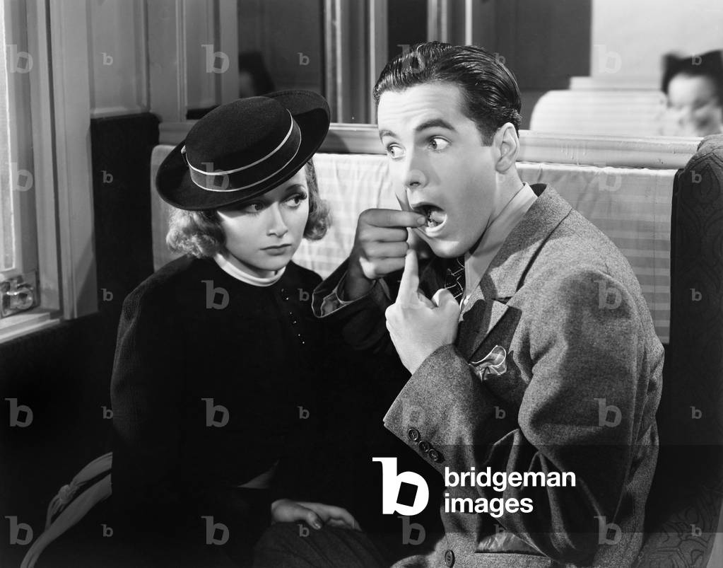 Man Showing Woman Inside of Mouth