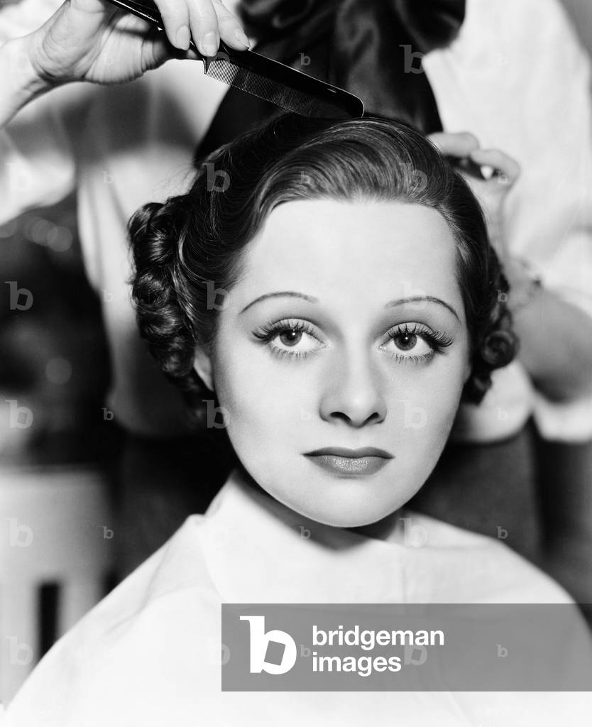 Hairdresser Combing a Young Woman's Hair