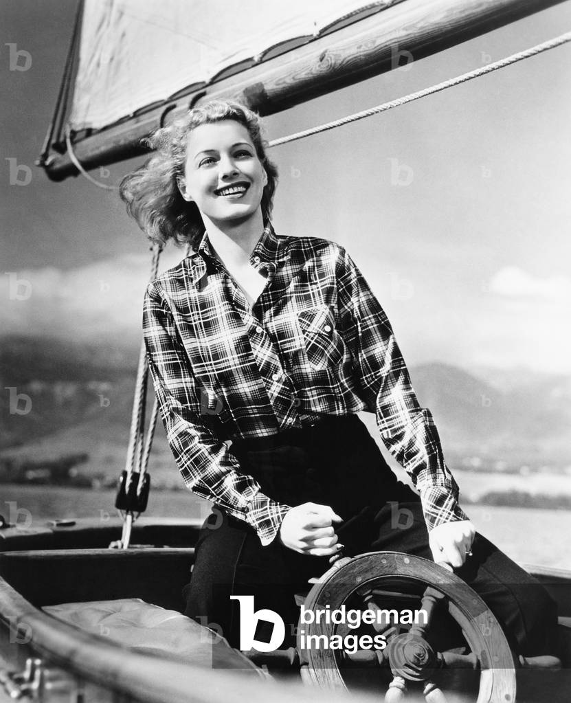 Young Woman Standing at the Helm of a Sailboat and Holding the Wheel, 1920-40s (b/w photo)