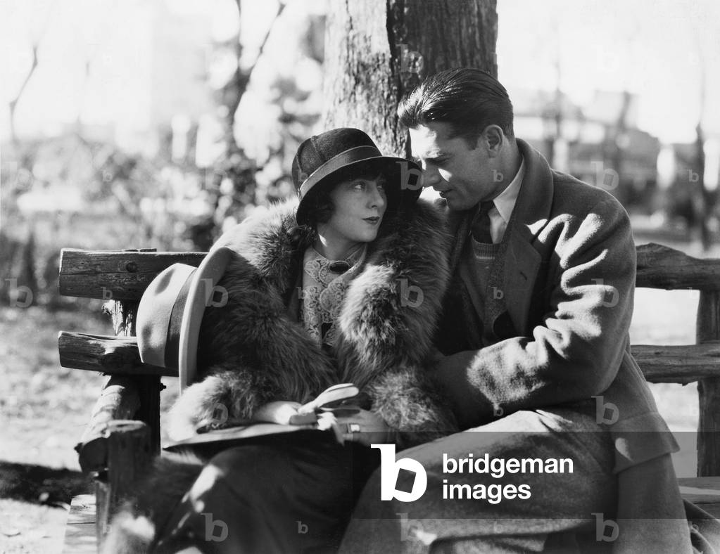 Couple in Each Others Arms Sitting on a Park Bench