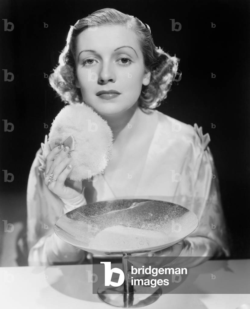 Young Woman Using a Powder Puff