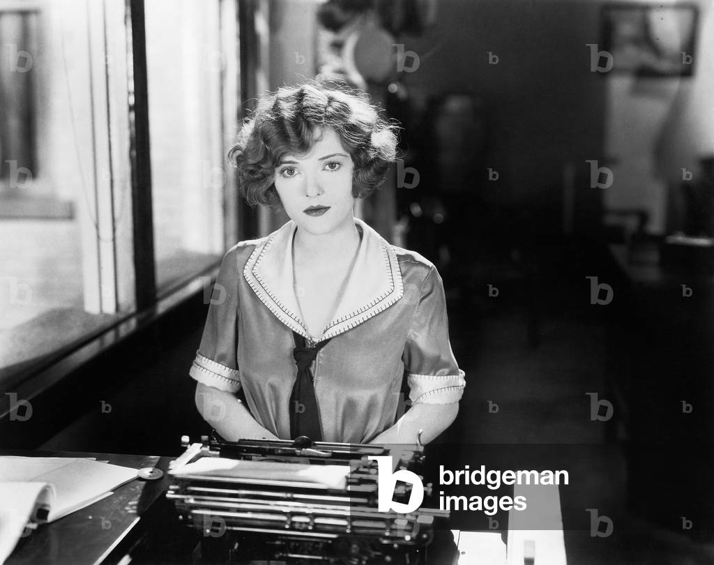 Young Woman Sitting in Front of a Typewriter