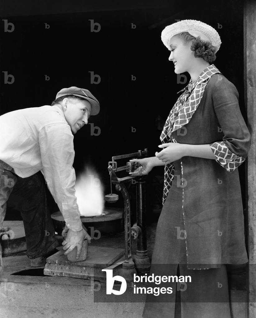 Woman with Man at Foundry Weighing Silver