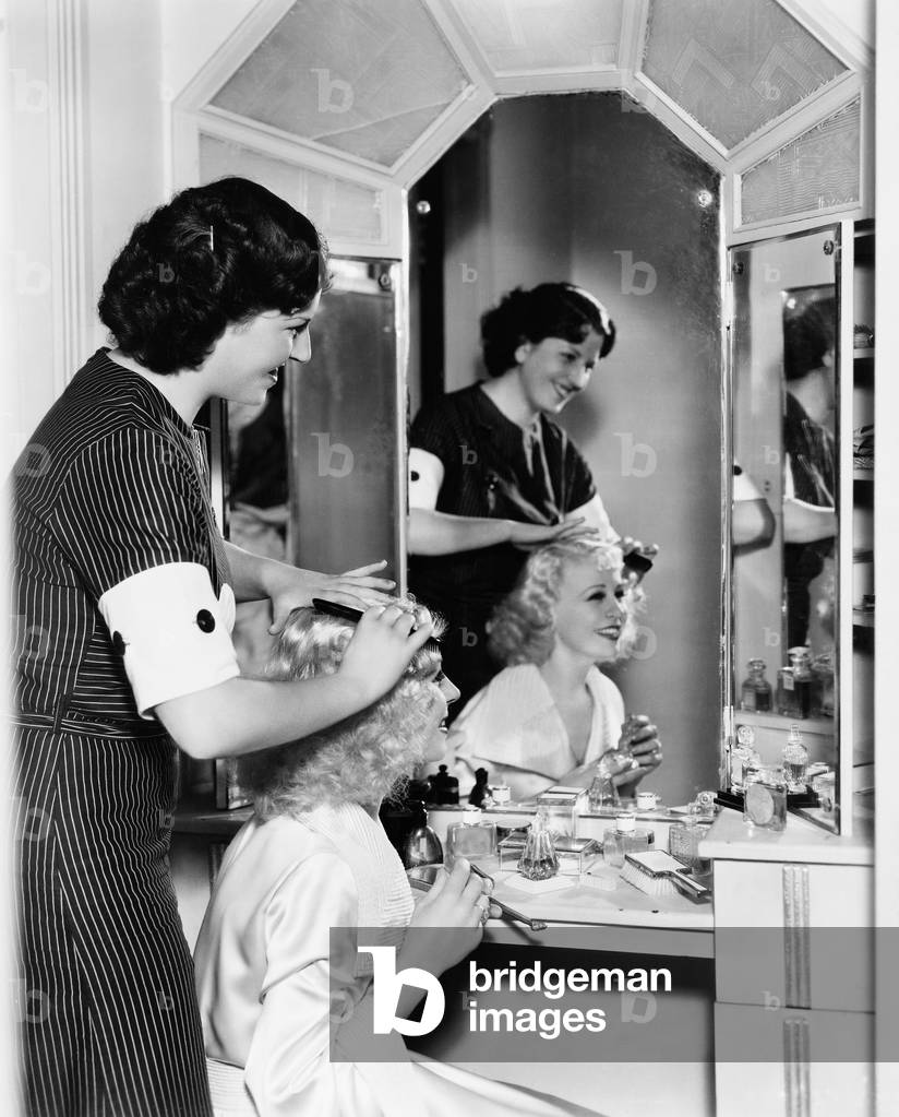 Woman Combing Another Womans Hair