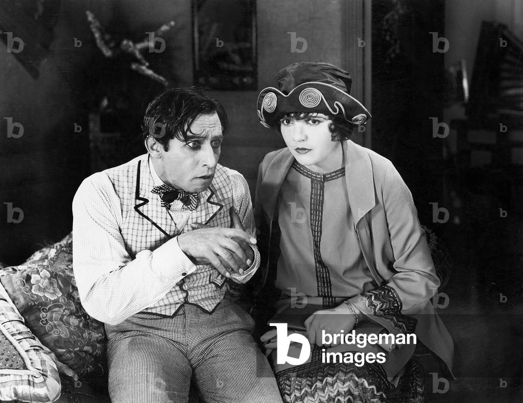 Couple Sitting Together on a Sofa Looking Worried