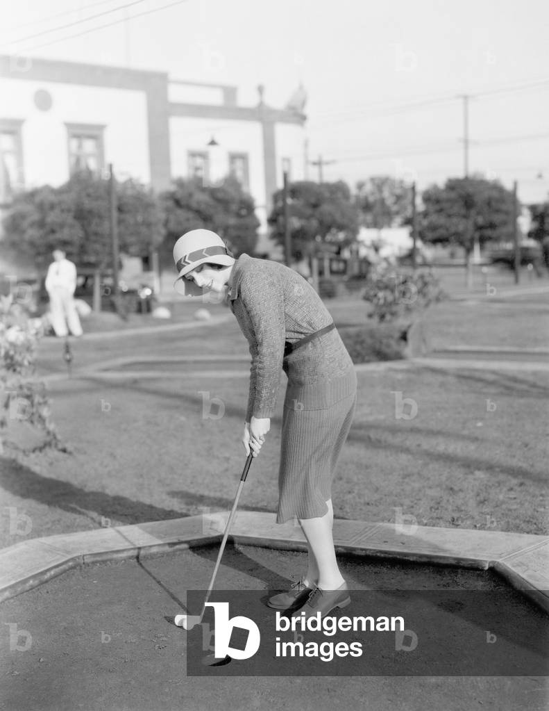 Young Woman Playing Mini Golf