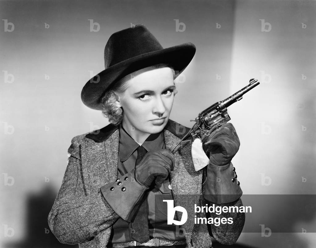 Portrait of a Young Woman Cleaning a Handgun