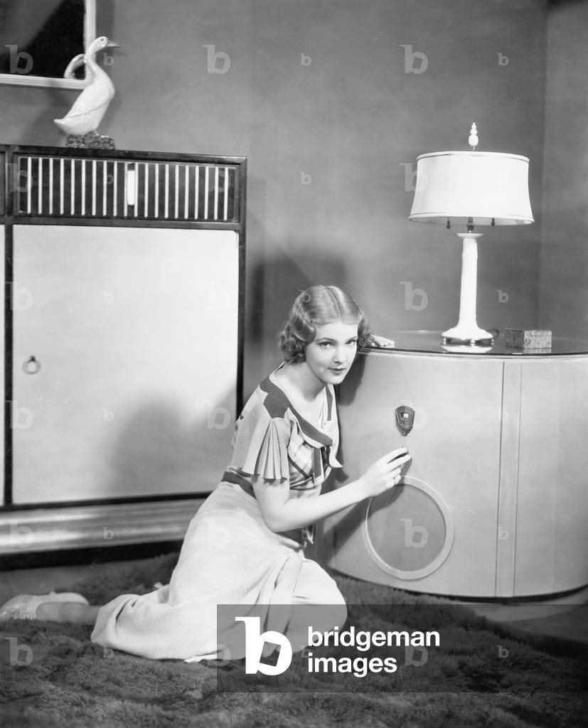 Woman Sitting on the Floor Listening to her Radio