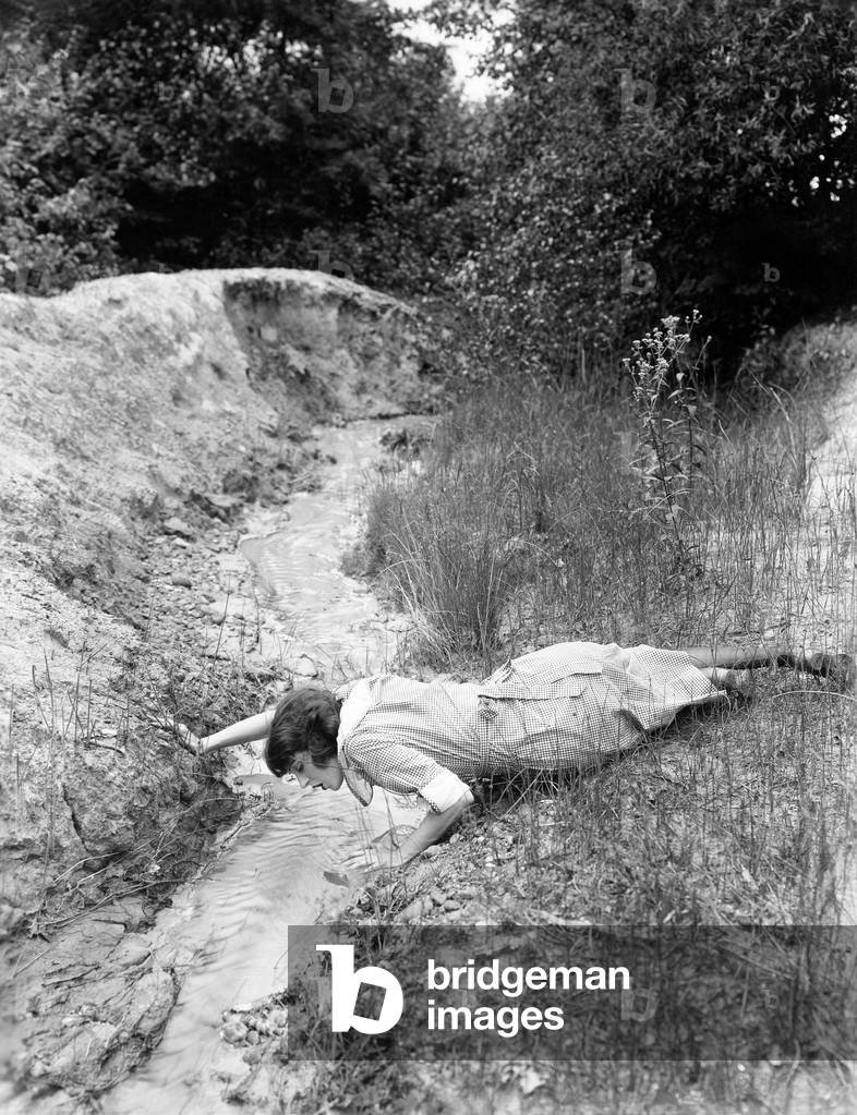 Woman Drinking From TiNY Stream