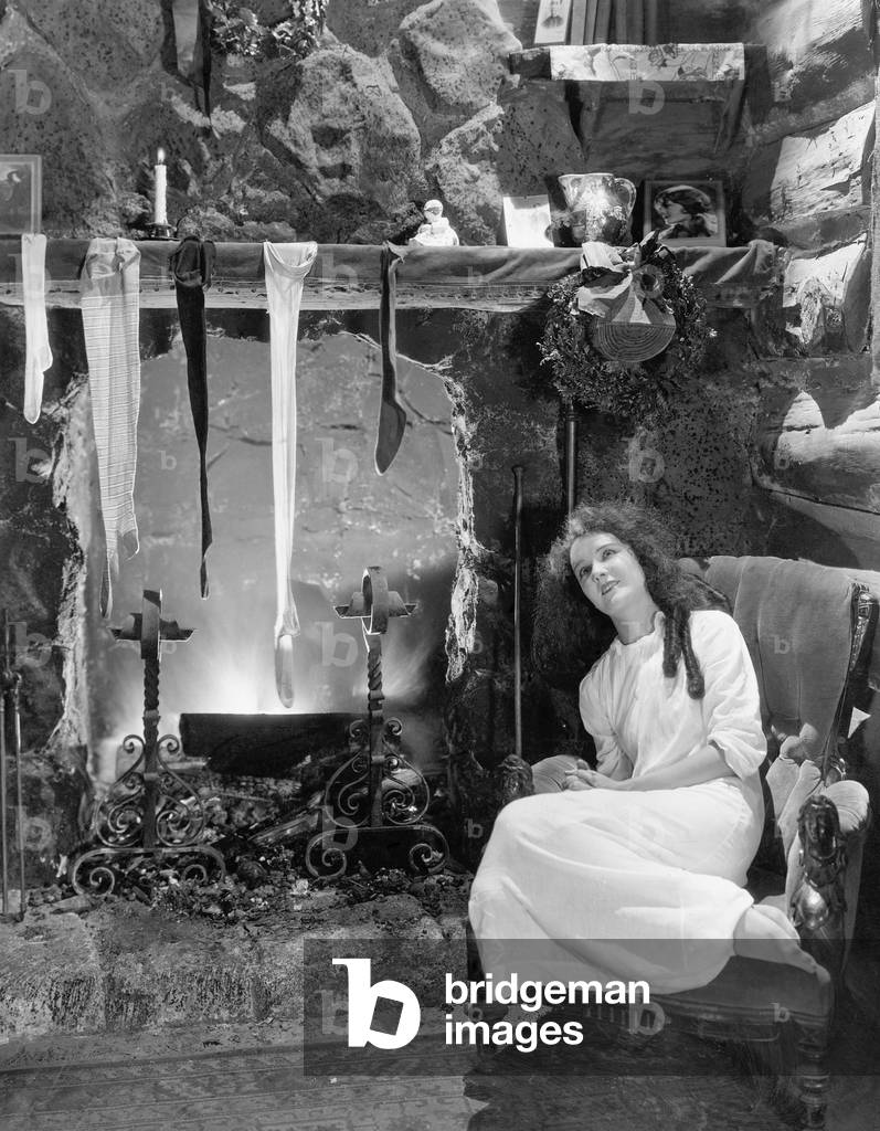 Young Woman Sitting in Front of a Fireplace, Drying her Stockings