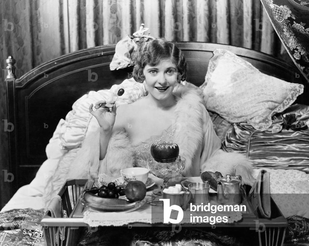 Woman Eating Breakfast in Bed