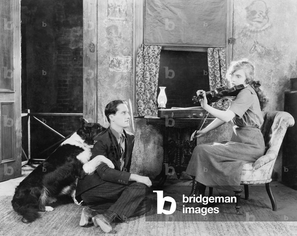 Woman Playing the Violin for her Boyfriend and Dog