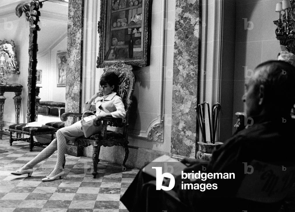 Audrey Hepburn seated on a chair in a luxurious house