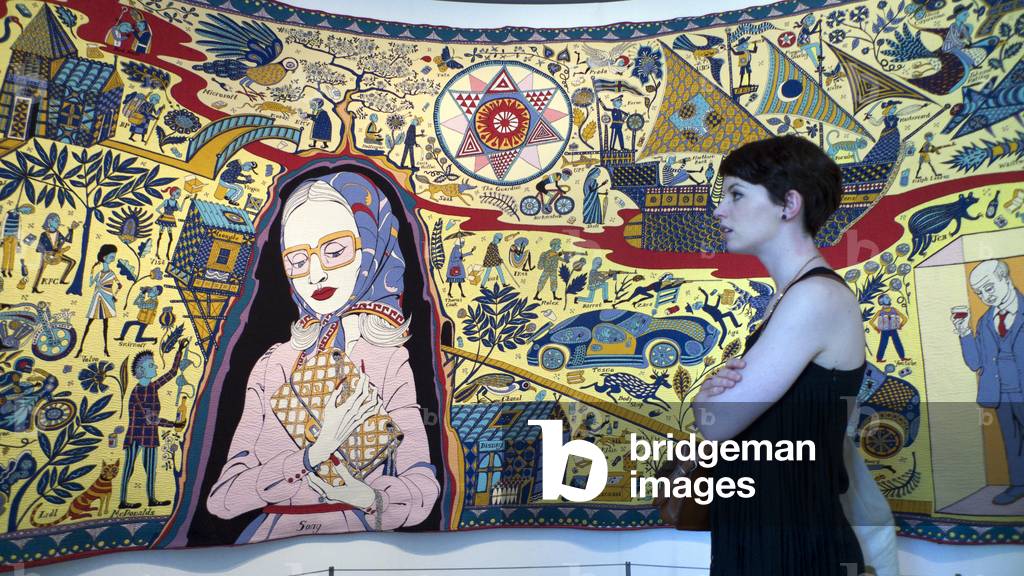 A young woman looking at the the Walthamstow Tapestry