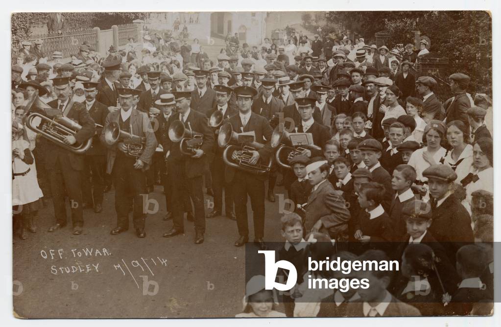 Brass band and large group of followers at the outbreak of the first World War. Studley. September 7th 1914. [The child in the Eton collar in the centre of the photograph was John Thompson who later became a local brewer]