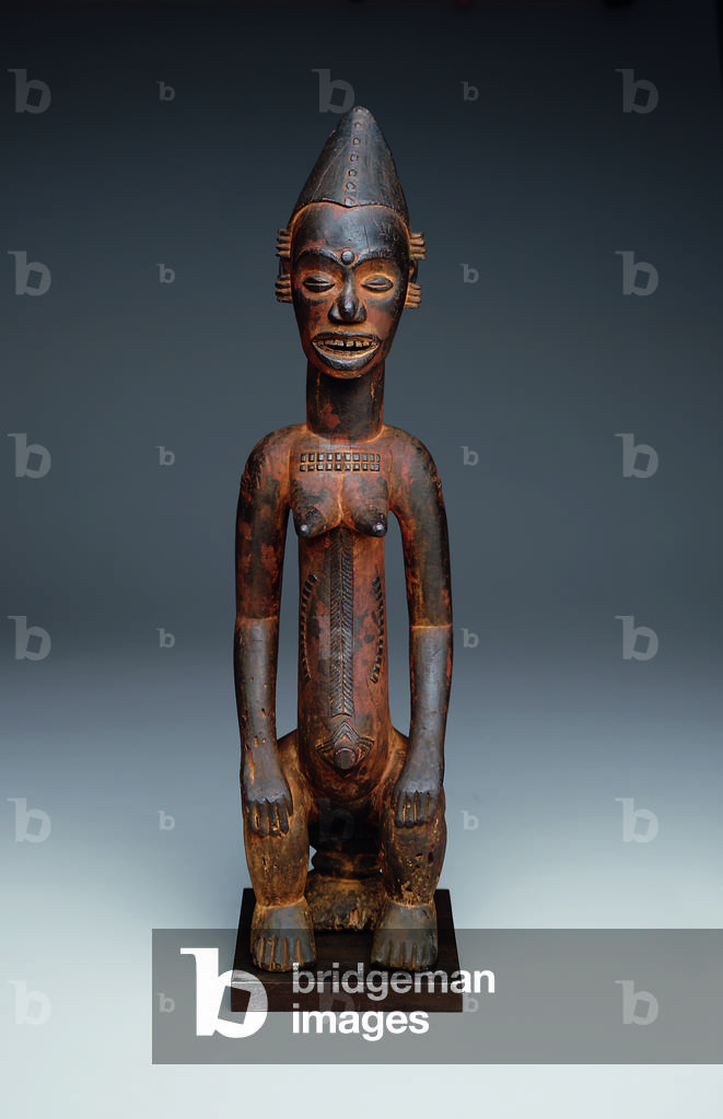 Seated female shrine figure, early 20th century (wood and pigment)