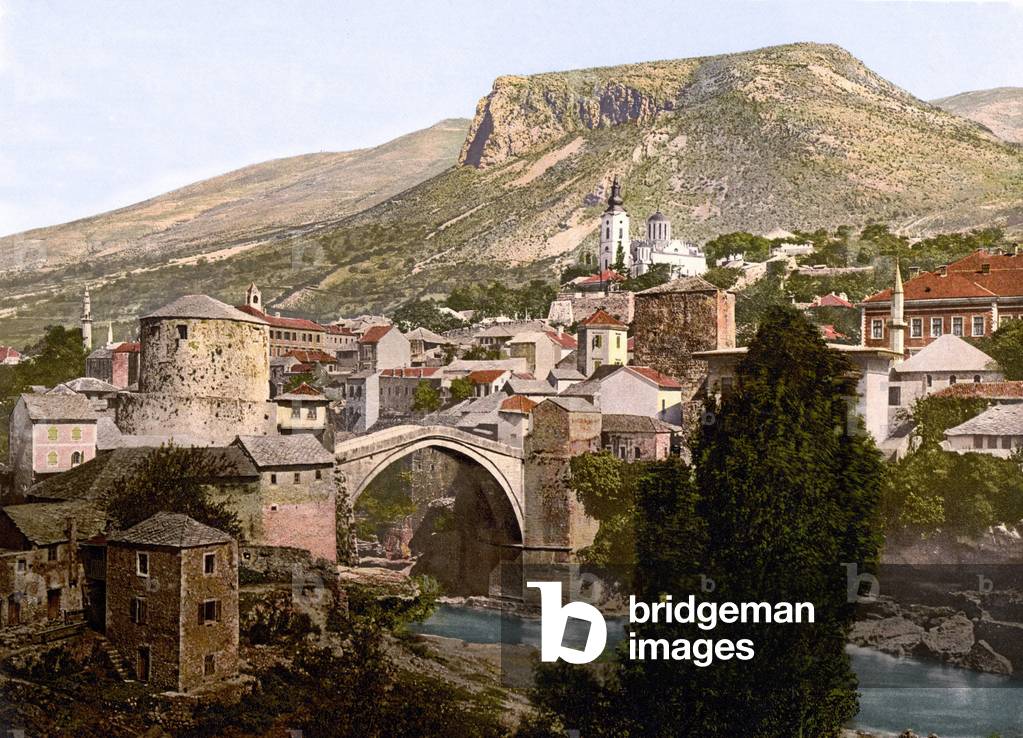 Mostar bridge in former Yugoslavia, present-day Bosnia-Herzegovine around 1930. The bridge dating from 1566 was destroyed during the war during a bombardment in 1993, now under reconstruction. Photochrome 1901. Leemage Collection