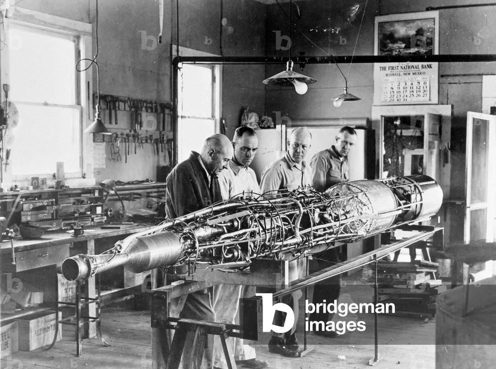 Robert Hutchings Goddard, American physicist, and his assistants, checking the fuel pump of a rocket at the research centre near Roswell, New Mexico, 1940 (photo)