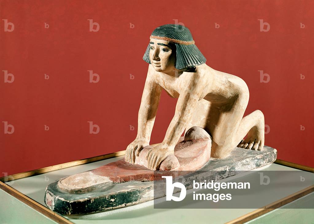 Model of a woman grinding grain, Old Kingdom (polychrome stone)