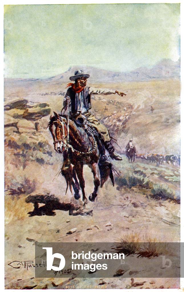Cowboy on horseback leading the herd