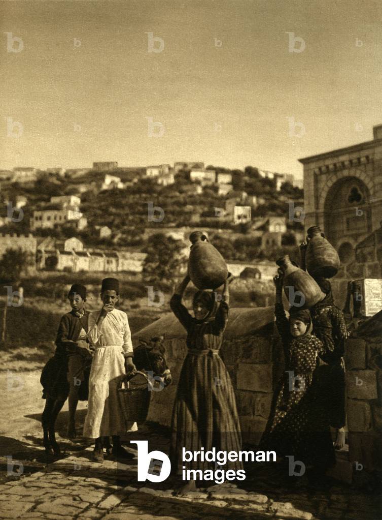 Nazareth, girls carrying water containers at Mary's Well, 1925 (b/w photo)