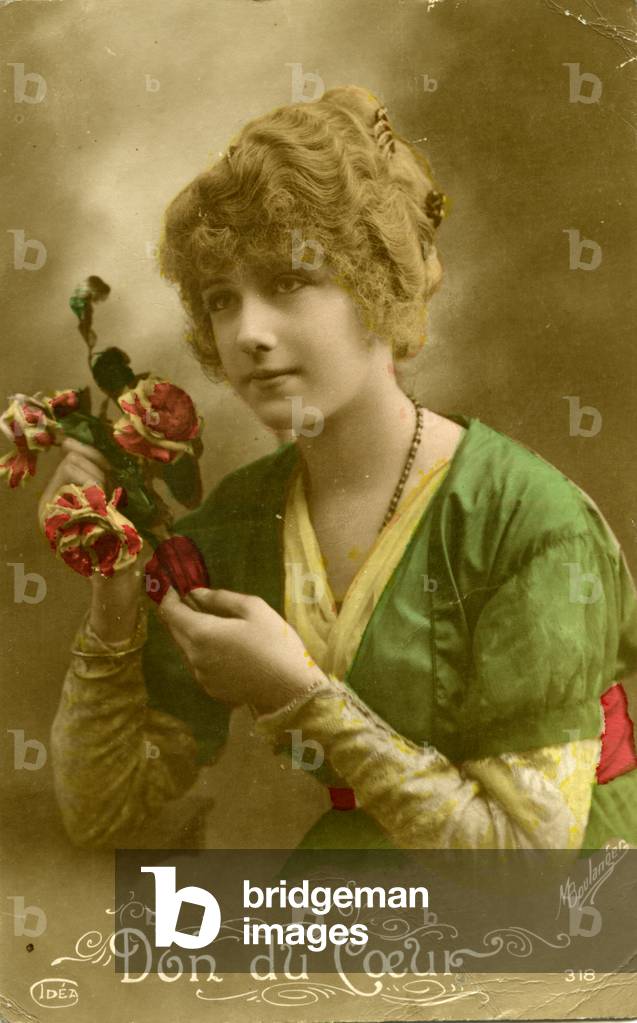 Young woman holding flowers 'Don de Coeur'