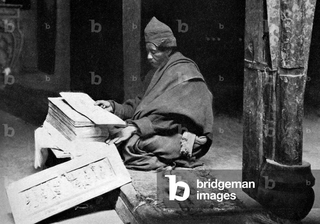 Tibetan monk reading the Kangyur