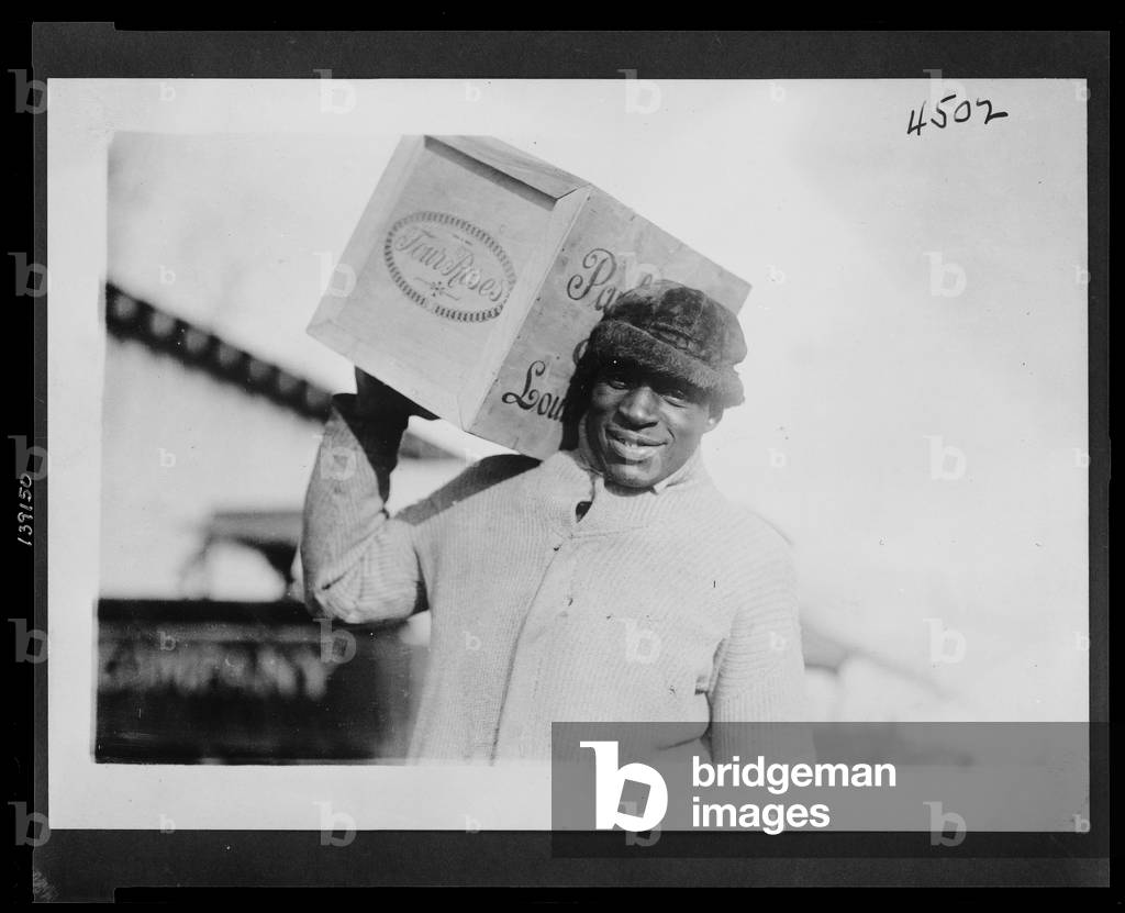 African American man carrying a case of 