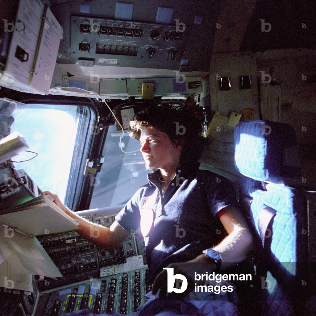 American astronaut Sally K. Ride monitors control panels on the Flight Deck, 1983 (photo)