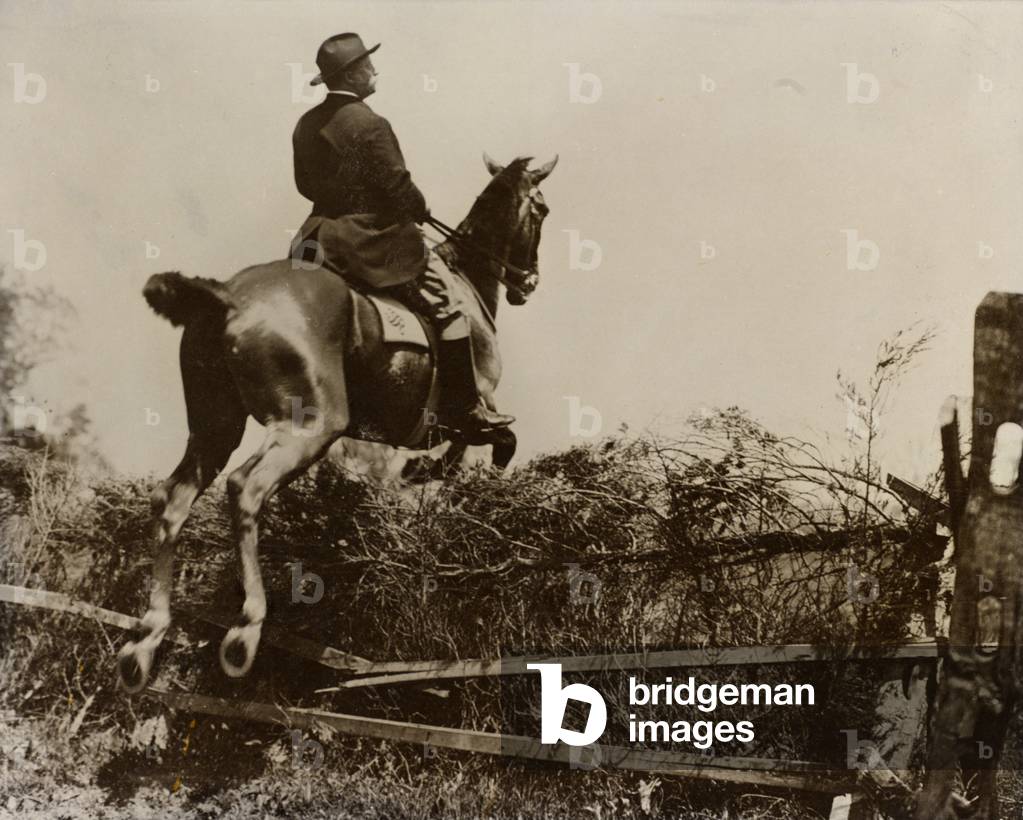 Theodore Roosevelt horseback riding, jumping over a fence, c.1902 (b/w photo)