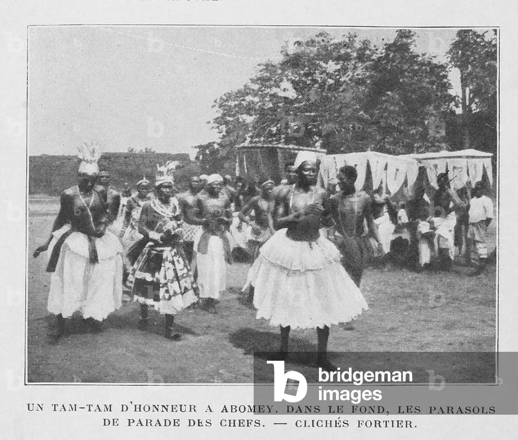 A Tam-Tam of honour in Abomey with parasols of the chiefs in the background, 1912 (b/w photo)